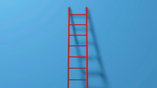 blue wall with red ladder against it