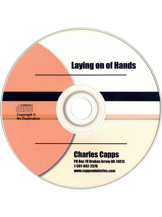 CD with 'Laying on of Hands' by Charles Capps on a white background