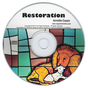 CD with stained glass design and lion illustration, featuring text 'Restoration' by Annette Capps. cappsministries.com