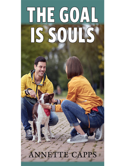 Pamphlet cover for 'The Goal Is Souls' by Annette Capps, featuring a photo of a smiling man and woman crouching down to pet a brown and white dog in a park, www.cappsministries.com