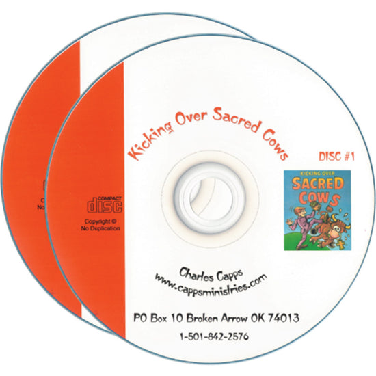 Two compact discs for 'Kicking Over Sacred Cows by Charles Capps" shown on a white background, with one disc partially covering the other. The front disc is white with orange text and a small colorful illustration, while the rear disc is solid orange. cappsministries.com