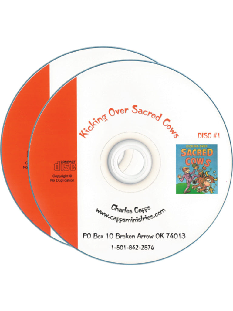 Two compact discs for 'Kicking Over Sacred Cows by Charles Capps" shown on a white background, with one disc partially covering the other. The front disc is white with orange text and a small colorful illustration, while the rear disc is solid orange. cappsministries.com
