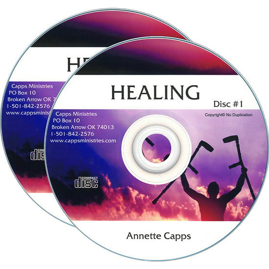 Two CDs for 'Healing Disc #1' by Annette Capps, featuring a purple and pink sky design with a silhouette of a person holding healing tools. cappsministries.com