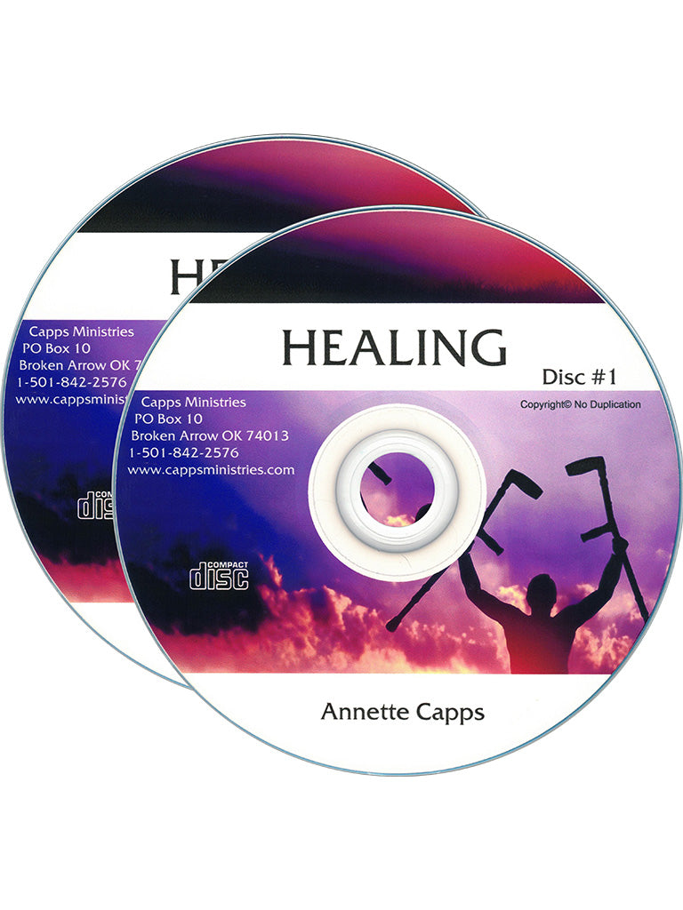 Two CDs for 'Healing Disc #1' by Annette Capps, featuring a purple and pink sky design with a silhouette of a person holding healing tools. cappsministries.com