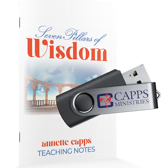 USB flash drive with Capps Ministries logo next to a note book titled 'Seven Pillars of Wisdom' by annette capps www.cappsministries.com