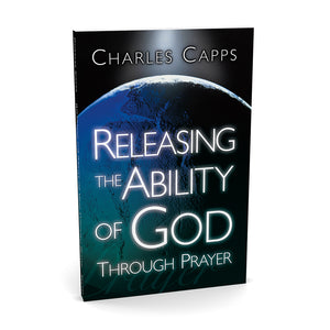 Book cover of 'Releasing the Ability of God Through Prayer' by Charles Capps with a world map background.